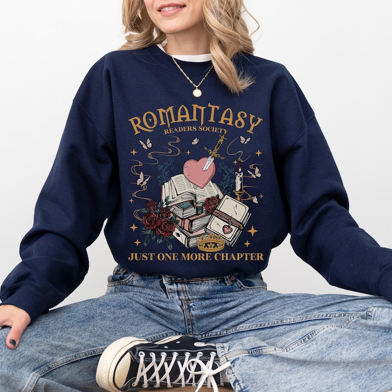a woman sitting on the floor wearing a sweatshirt