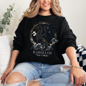 a woman sitting on a couch wearing a black sweatshirt
