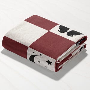 a red and white checkered wallet sitting on top of a table