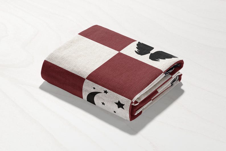 a red and white checkered wallet sitting on top of a table