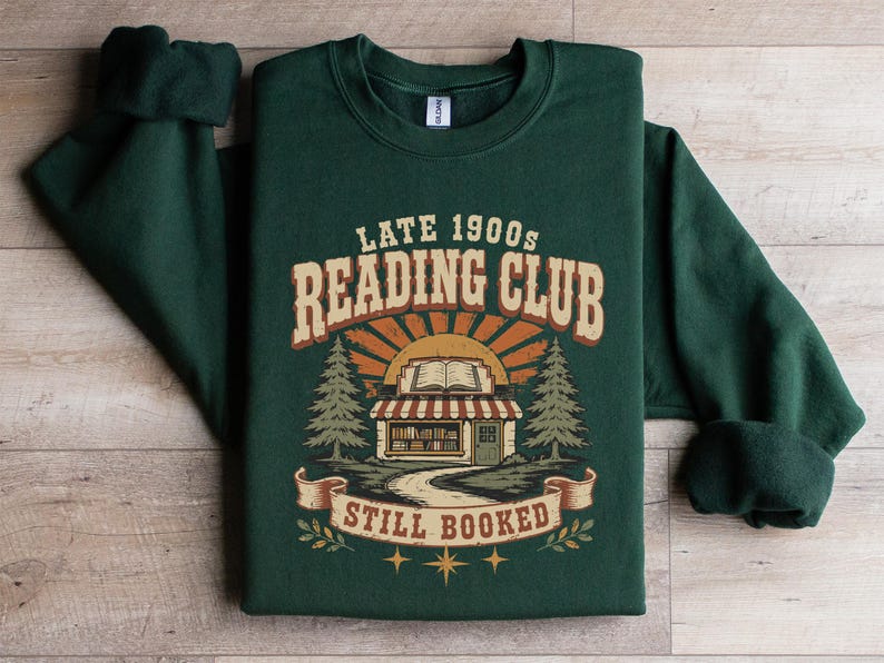 Green sweatshirt with "Late 1900s Reading Club Still Booked" graphic.