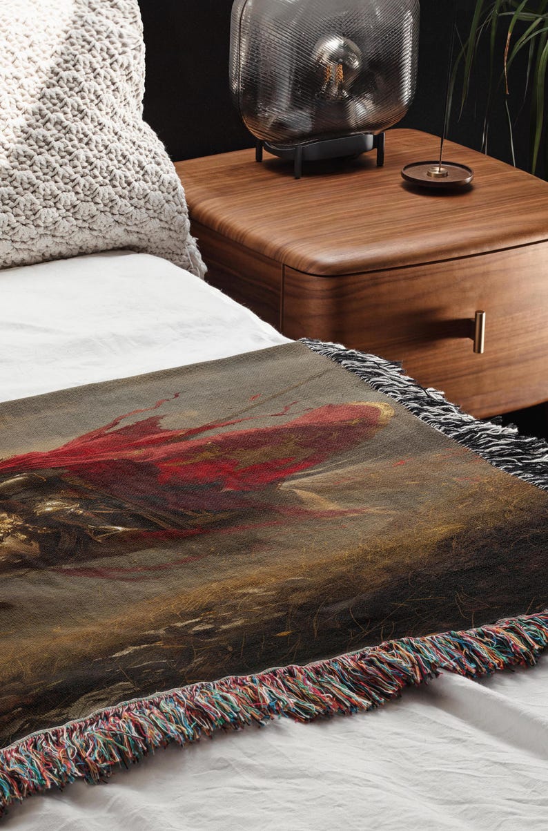 a bed with a painting on it next to a night stand