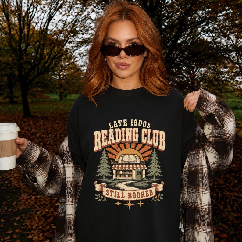 Black t-shirt with "Late 1900s Reading Club Still Booked" graphic and autumn trees.