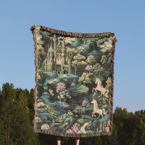 a person standing in a field holding a blanket