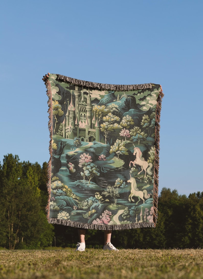 a person standing in a field holding a blanket