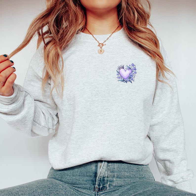 a woman wearing a sweatshirt with a heart on it