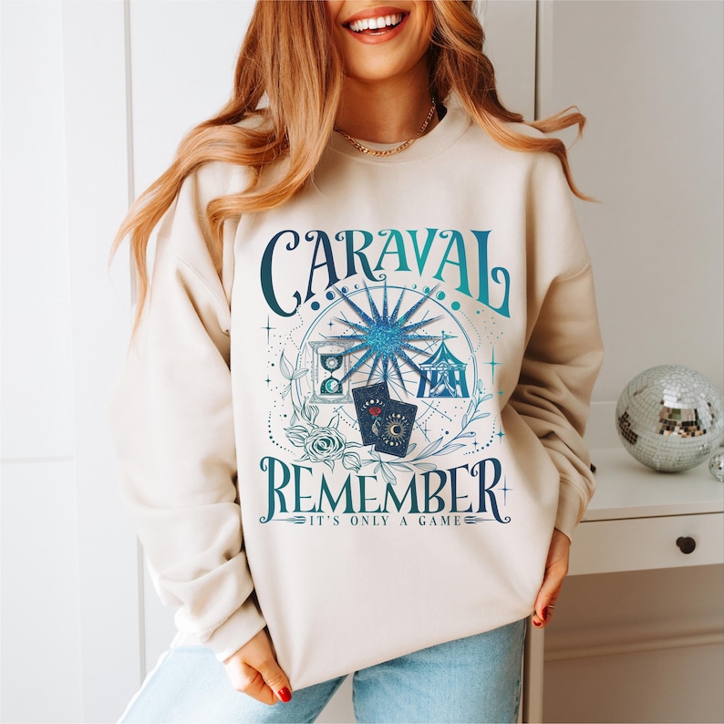 a woman wearing a sweatshirt that says caraval is a reminder