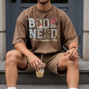 Brown t-shirt with "BOOK NERD" text in collage style.