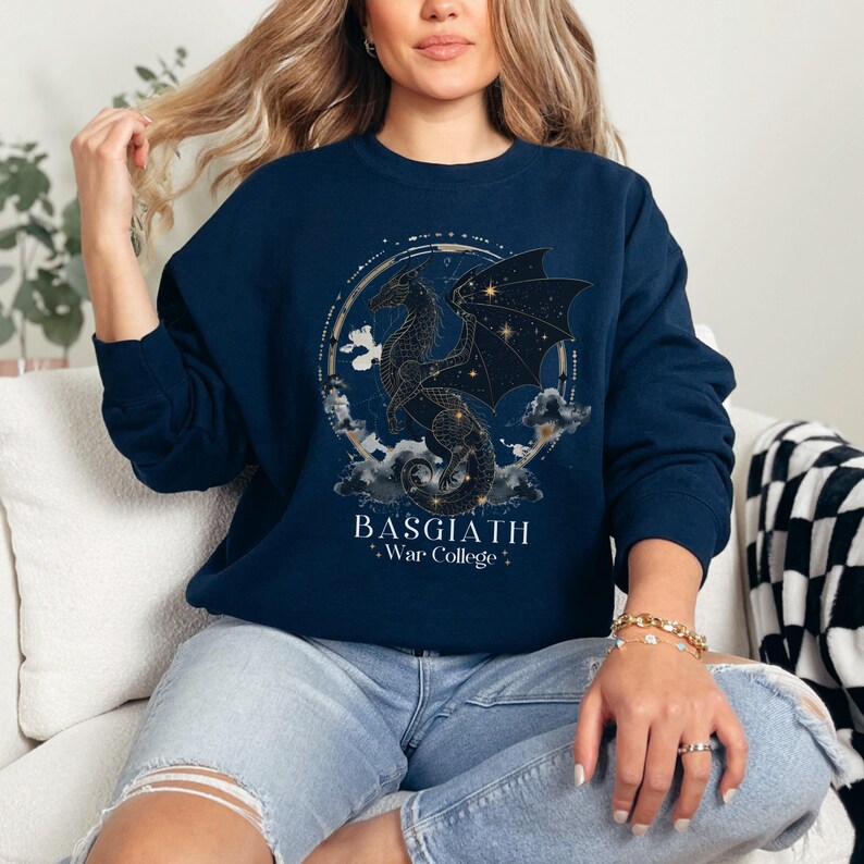 a woman sitting on a couch wearing a blue sweatshirt
