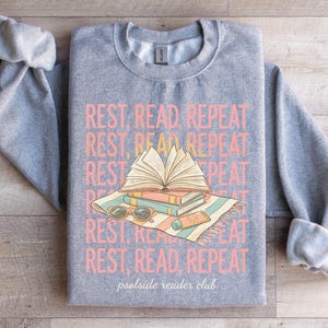Gray sweatshirt with "REST, READ, REPEAT" and "poolside reader club" text.