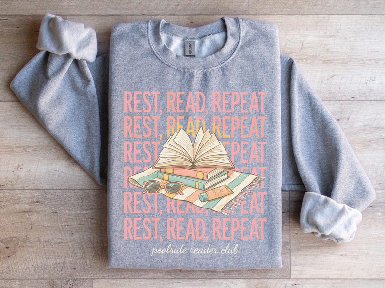 Gray sweatshirt with "REST, READ, REPEAT" and "poolside reader club" text.