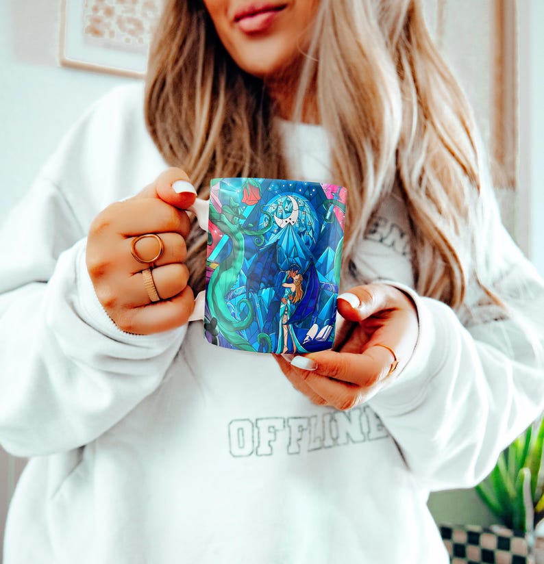 a woman is holding a coffee mug in her hands