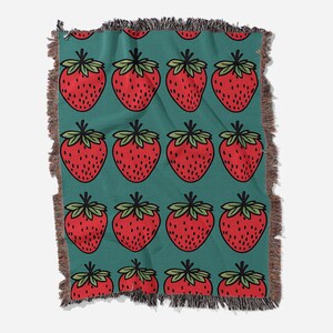 a blanket with a pattern of strawberries on it