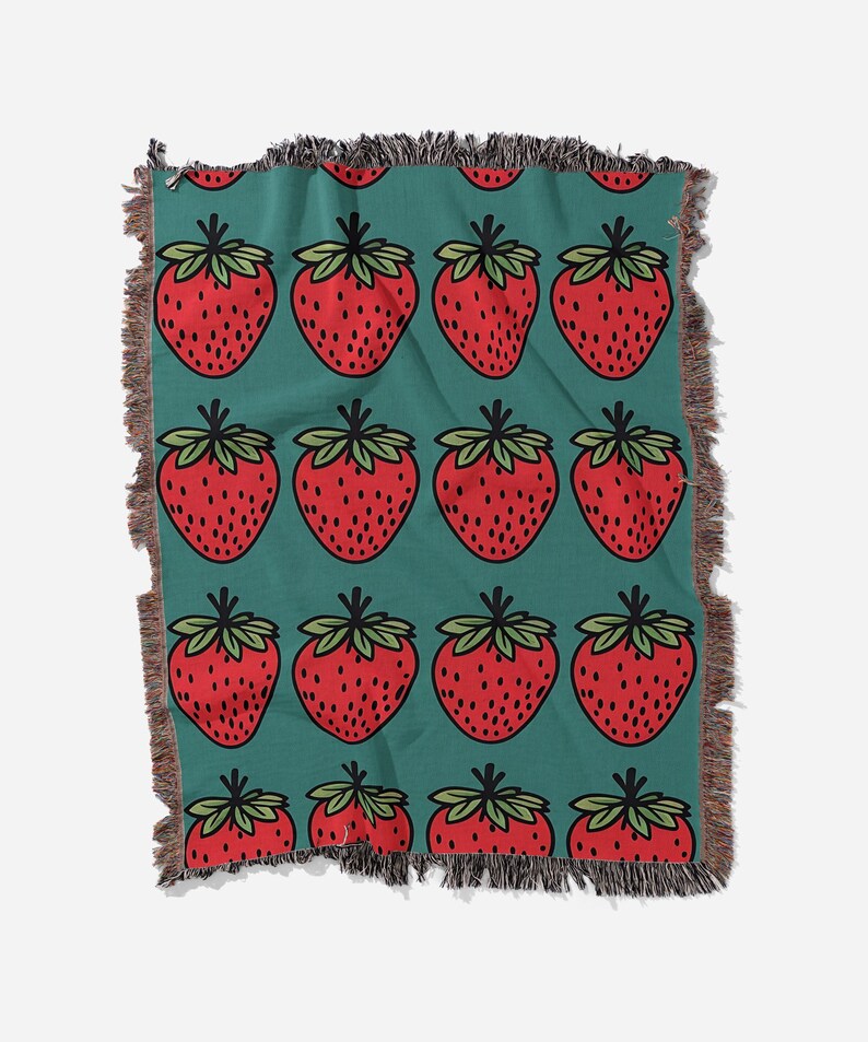 a blanket with a pattern of strawberries on it