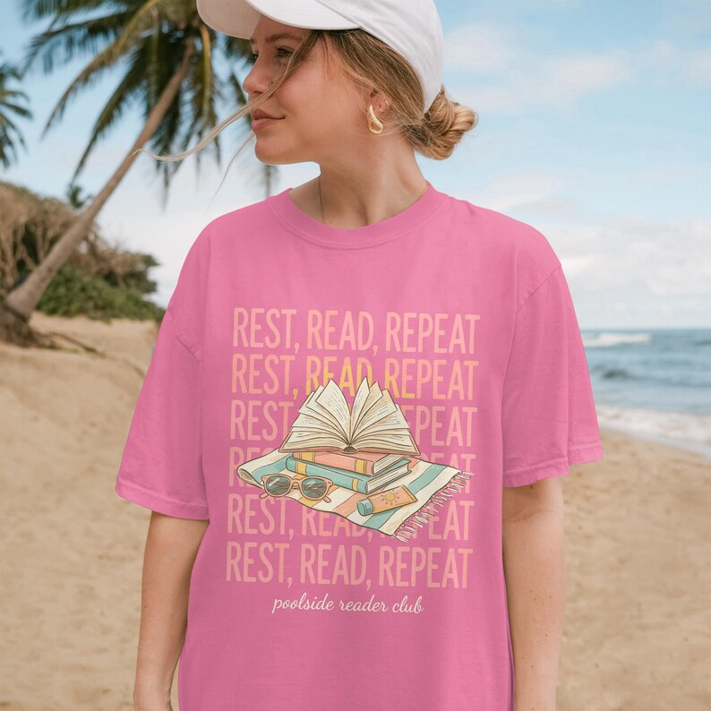 Pink t-shirt with "REST, READ, REPEAT" and "poolside reader club".