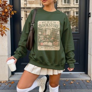 Green sweatshirt with "Meet me at the bookstore" book-themed graphic.