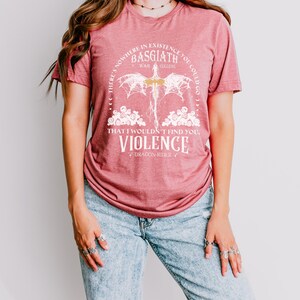 a woman wearing a red shirt and ripped jeans