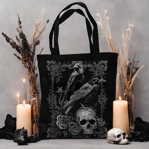 a black tote bag with a crow on it