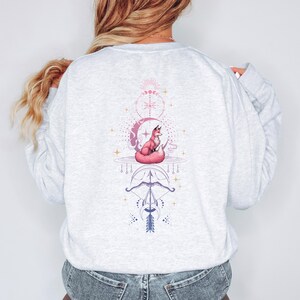 the back of a woman's sweatshirt with a picture of a cat on it