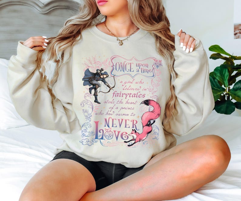 a woman sitting on a bed with her legs crossed
