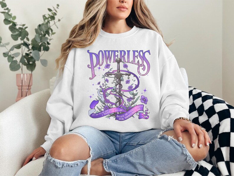 a woman sitting on a couch wearing a sweatshirt
