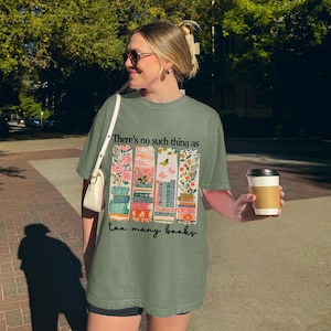 Woman wearing a graphic tee with "There's no such thing as too many books."
