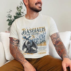 a man with tattoos sitting on a white couch
