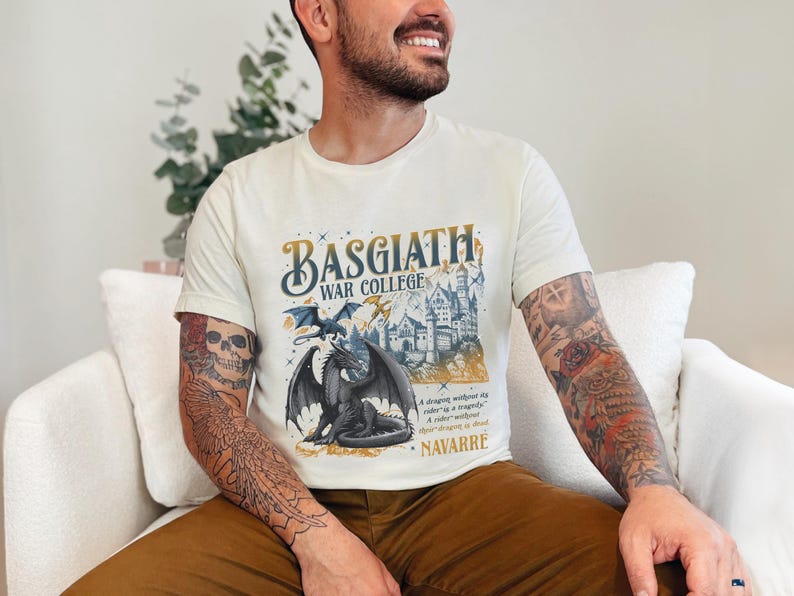a man with tattoos sitting on a white couch