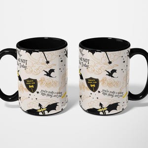 two black and white coffee mugs sitting next to each other