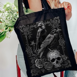 a woman sitting on a chair holding a black tote bag