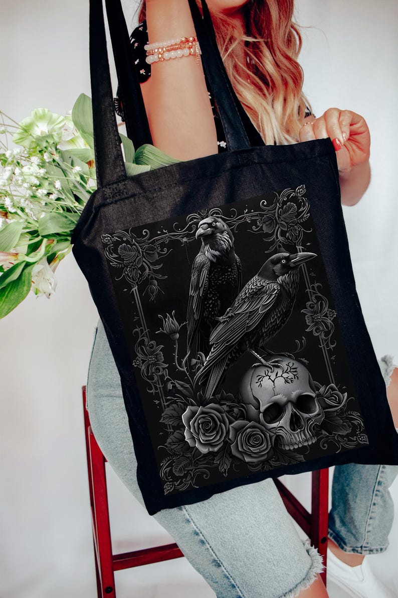 a woman sitting on a chair holding a black tote bag