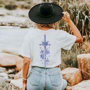 a woman wearing a cowboy hat and jeans
