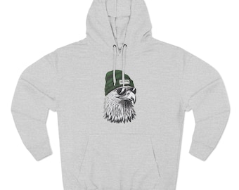 Könnte beinhalten: Grauer Kapuzenpullover mit einem Aufdruck eines Adlers, der eine grüne Mütze und eine Sonnenbrille trägt.