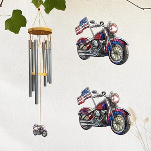 May include: A decorative wind chime with silver-colored tubes and a wooden top, alongside two motorcycle wall hangings. The motorcycles feature red, white, and blue paint, and an American flag. The wind chime has a small motorcycle charm.