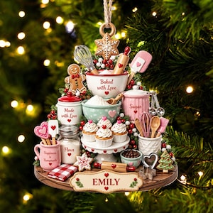 May include: A tiered Christmas tree ornament featuring baking supplies including a mixing bowl with 'Baked with Love', a jar labeled 'Sugar', a jar labeled 'Flour', a mug labeled 'Happiness is Homemade', and a base plaque with the name 'EMILY'.