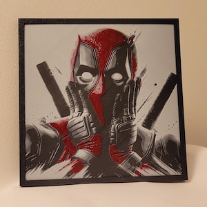 May include: A black and white illustration of Deadpool, a superhero, with a red mask and a black and white background.