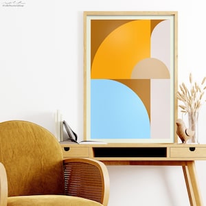 Può includere: Stampa d'arte geometrica astratta in una cornice di legno. La stampa presenta una composizione di forme arancioni, marroni, beige e blu.