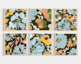 May include: Six framed floral art prints. Each square print features a close-up of a flower design in shades of blue, yellow, peach, and white against a dark background. The frames are a light wood color.