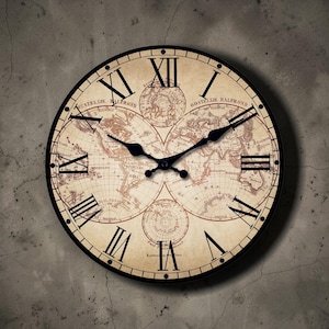Puede incluir: Reloj de pared redondo con un diseño de mapa vintage. La esfera del reloj presenta números romanos y manecillas negras. El reloj tiene un marco negro y está montado en una pared gris texturizada.