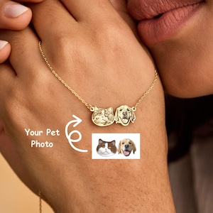 May include: A gold necklace with two pet portraits, a cat and a dog. The necklace is held in a person's hand, with the text "Your Pet Photo" and an arrow graphic. The necklace is from UniQHandmadeCo.