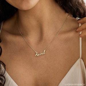 May include: A gold necklace with the name "Rachel" written in cursive script.