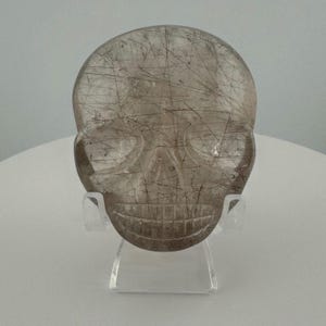 Red Rutile in Smokey Quartz Magical Child Palm Skull carved by Leandro de Souza