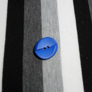 Blue oval button with two holes. 1 1/8&quot;.