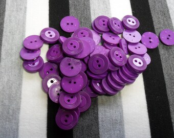 Purple round button. 1 button.