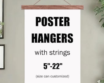 May include: A white poster with black text that reads "POSTER HANGERS with strings 5"-22" (size can customized)". The poster is hanging from a wooden dowel rod.