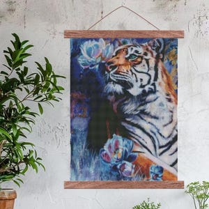 May include: A colorful painting of a white tiger with blue eyes, surrounded by purple and blue flowers. The tiger is looking up and to the right, with its mouth slightly open. The painting is framed in a wooden frame.