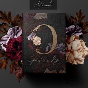 May include: A black card with a gold letter "O" surrounded by burgundy, cream, and purple flowers. The text "Ephelia May" is written in cursive below the letter. The card is surrounded by burgundy, cream, and purple flowers.