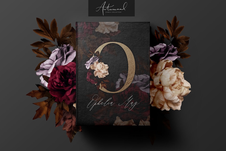 May include: A black card with a gold letter "O" surrounded by burgundy, cream, and purple flowers. The text "Ephelia May" is written in cursive below the letter. The card is surrounded by burgundy, cream, and purple flowers.