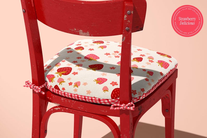May include: A red wooden chair with a cushion featuring a strawberry pattern. The cushion has a white background with red strawberries and pink flowers. The chair has a distressed finish and a gingham border.