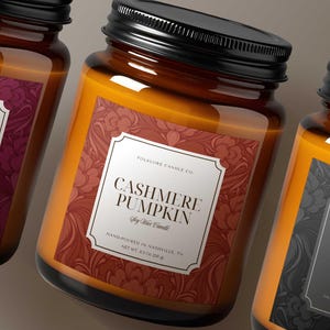 May include: Three glass jar candles with black lids. The labels read "Cranberry Woods", "Cashmere Pumpkin", and "Speakeasy & Smoke". The labels have decorative floral patterns and the text "Folklore Candle Co."